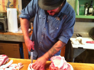 Chef Matt Elias teaching a small group how to properly butcher a pig